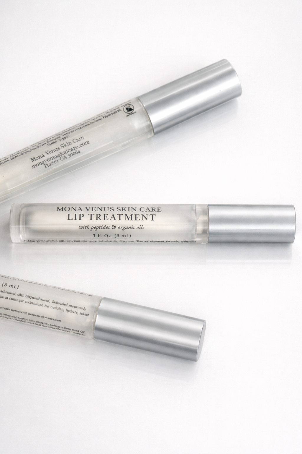 Three lip treatment containers from Mona Venus Skin Care on a white background